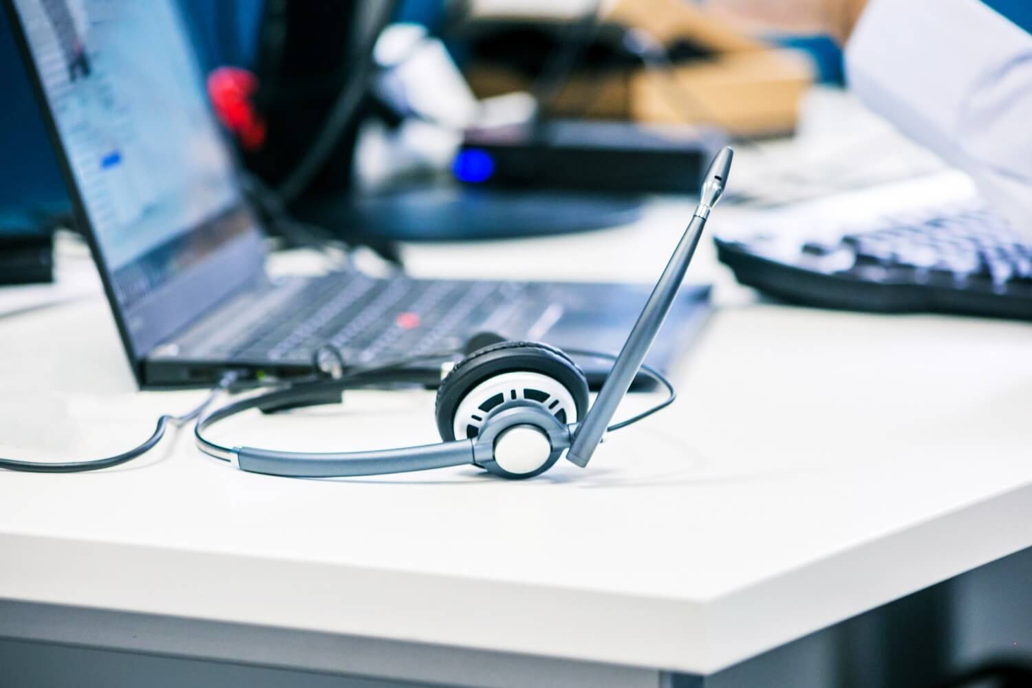 A headset and laptop on a desk