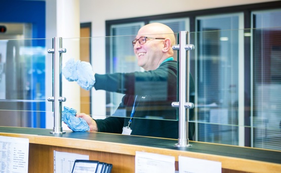 Man cleaning reception screen