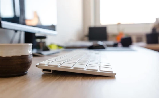 Close up of a desktop focusing on the keyboard