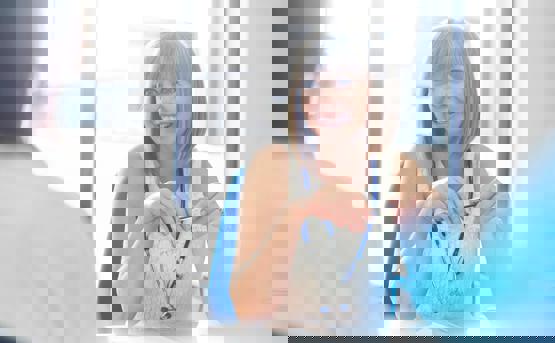 a medical professional smiles as she talks to a patient 