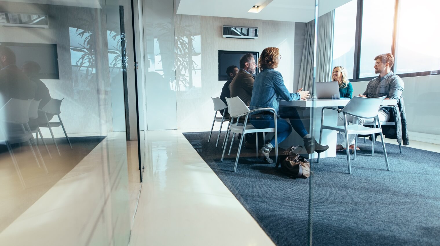 people meet in a modern glass office