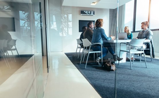 people meet in a modern glass office