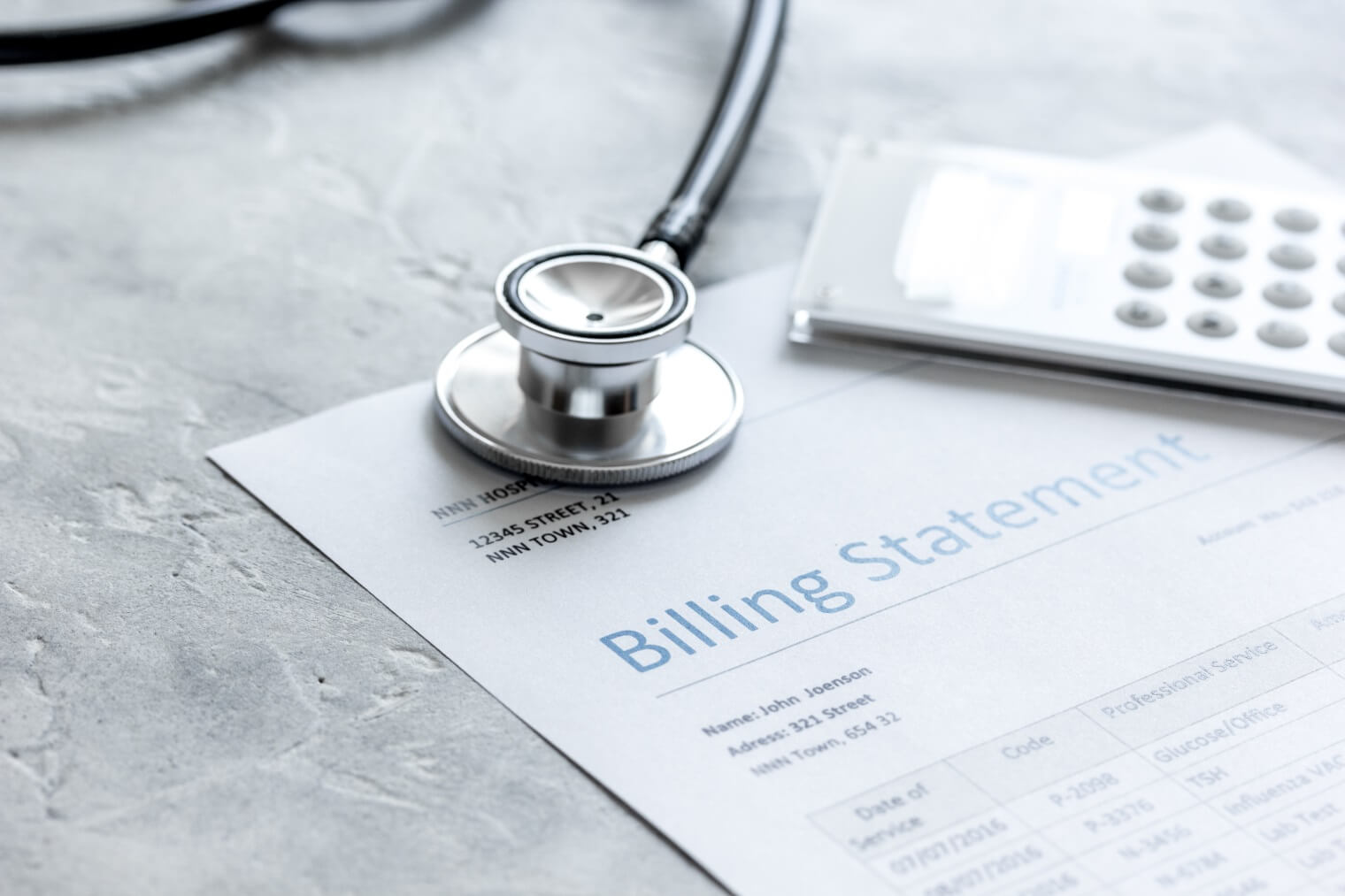 stethoscope rests on a billing statement 