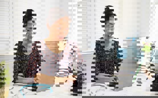 Women working on laptop with Stethescope on the desk