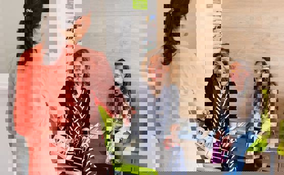 Nurse talking to mother and daughter at waiting area