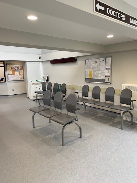 Waiting room with grey chairs and reception
