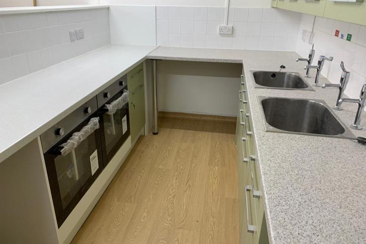 Rectangular kitchen with two sinks and two ovens and lots of worktop space