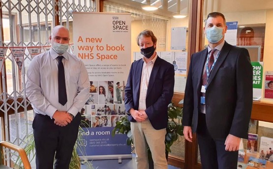 MP at Werrington Health Centre, standing in front of NHS Open Space banner
