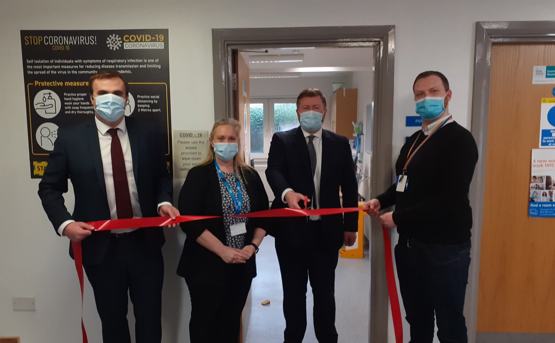 3 men and 1 woman ribbon cutting at Churchtown Health Centre