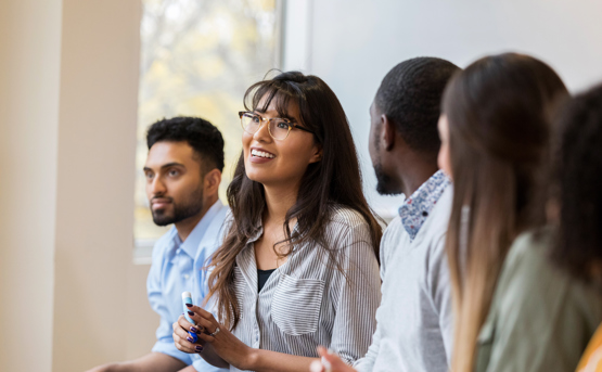 Group Of People Asking Questions In Meeting