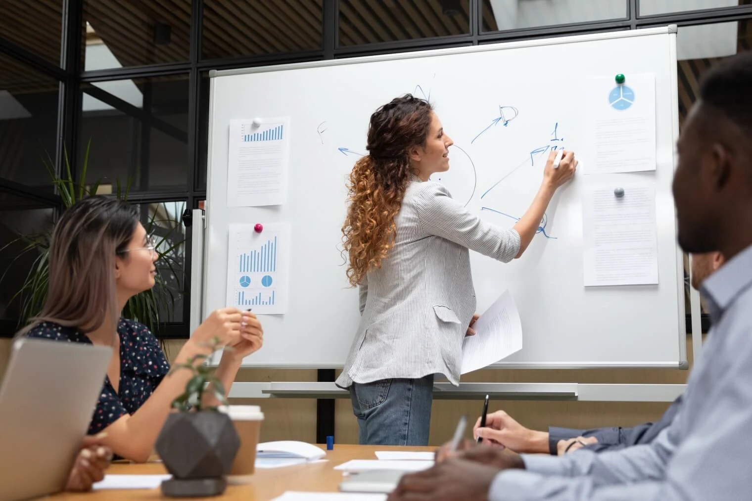 Woman Writing On Whiteboard In A Meeting 
