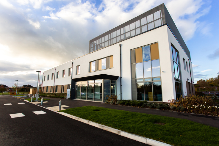 Exterior of the new two-storey Devizes Health Centre in Wiltshire. The building is one of the country's first net-zero integrated care centres, setting a new standard for health care infrastructure nationwide.
