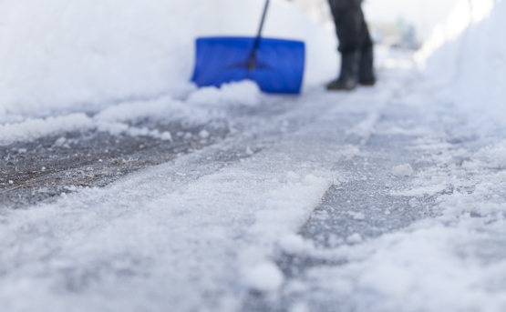 shovelling snow off a path preparing your property for winter