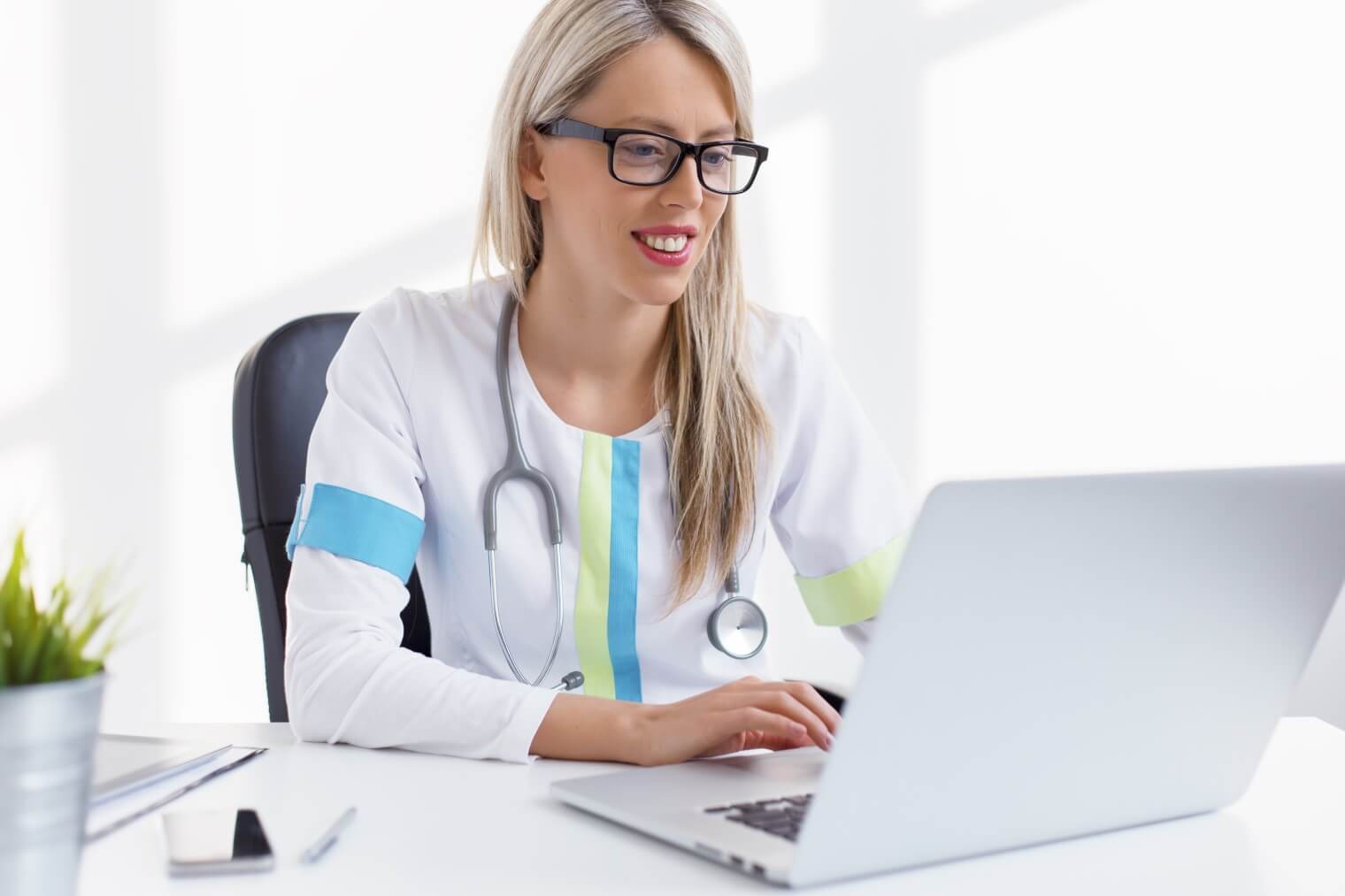 a medical professional looking at her laptop