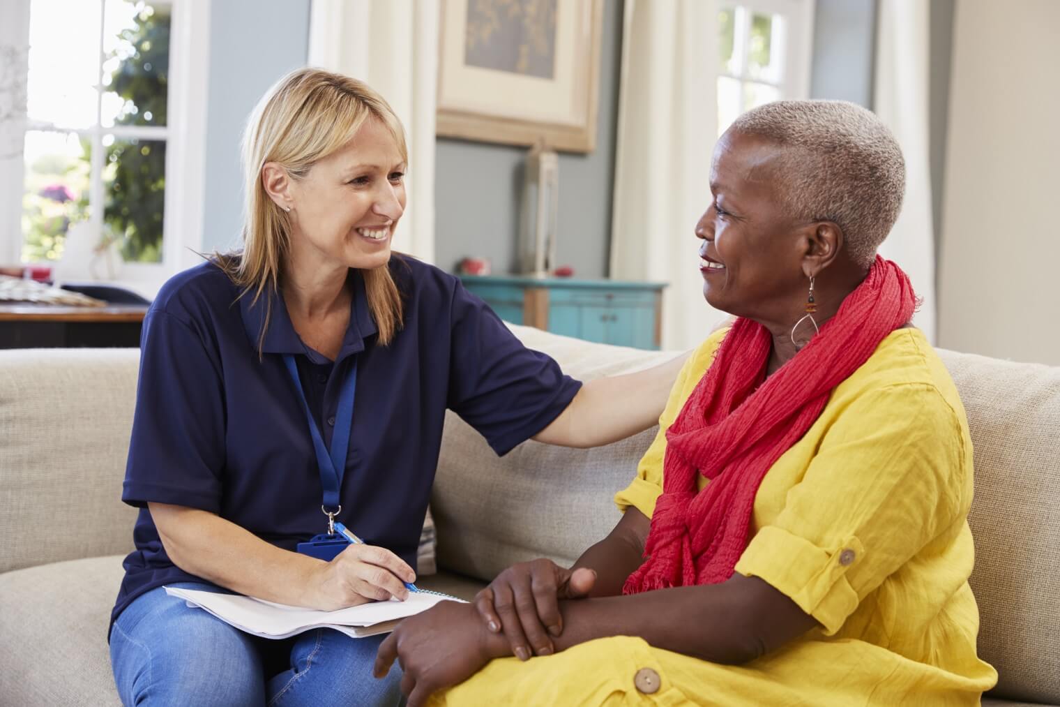 Female support worker interviewing senior woman 