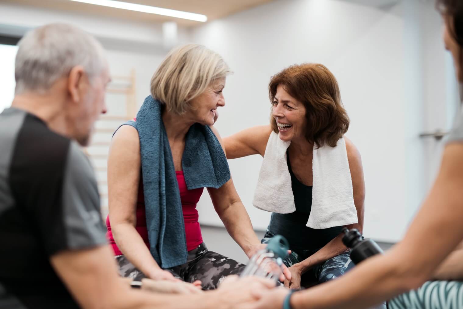 Two women laughing in group fitness class 